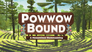 Wooden sign reading “POWWOW BOUND” and “A Menominee Homecoming” in forest amphitheater setting